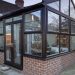 Brown gable end conservatory with French doors - New Look Double Glazing